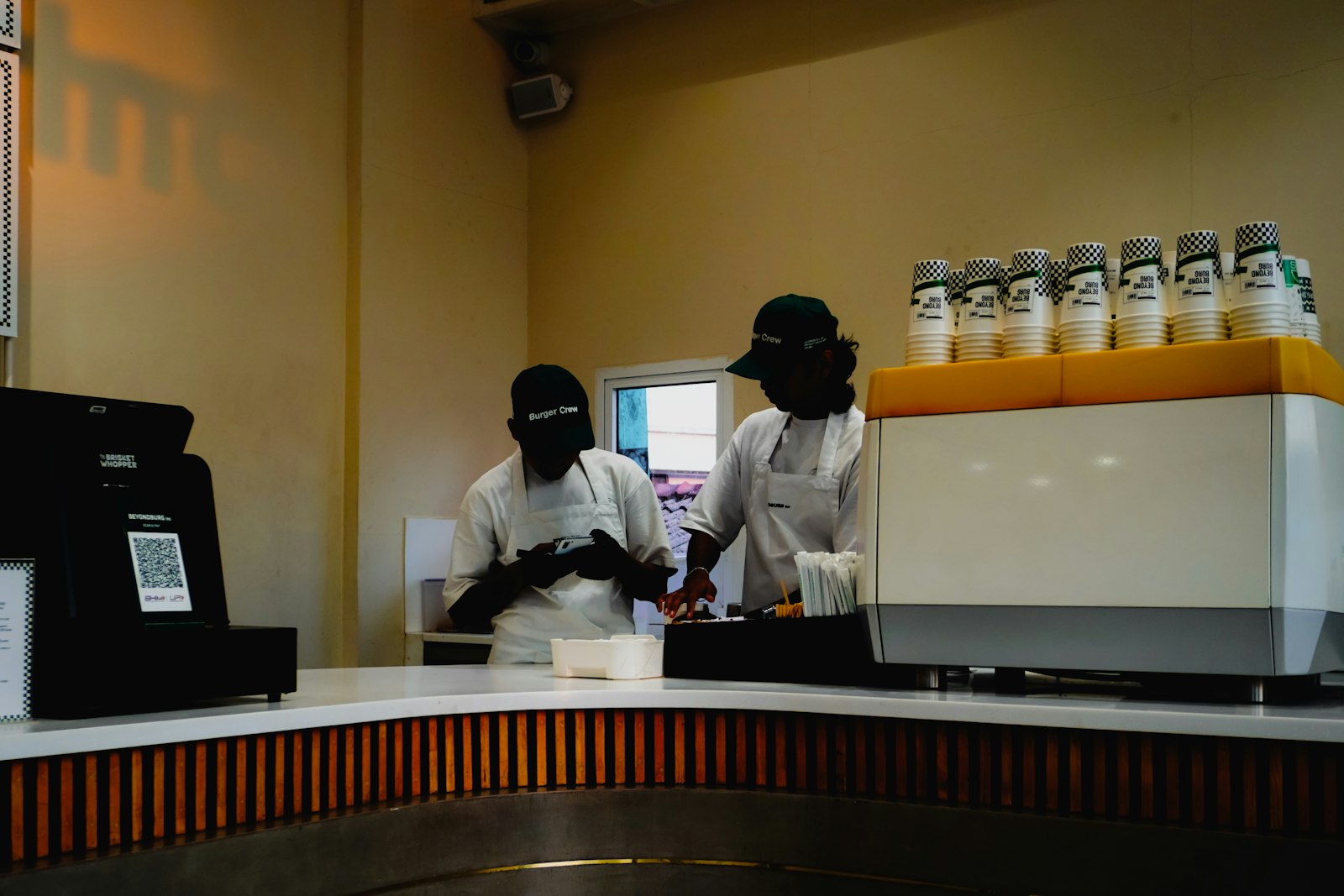 Two staff members working behind a counter